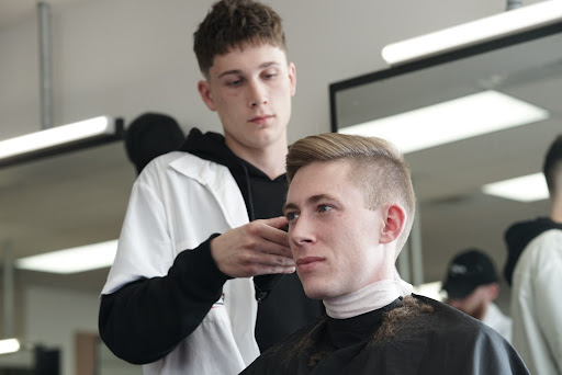 Student cutting a client's hair