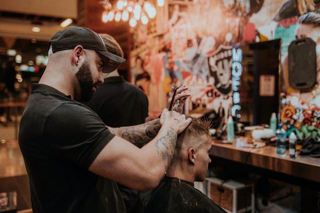 man getting a hair cut from a barber