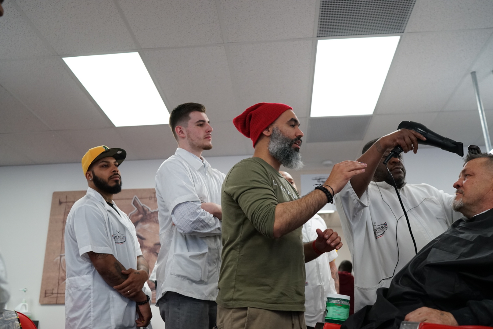 Barber instructor showing techniques to students