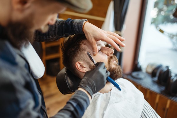 barber shaving mans face