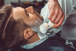 barber applying shaving cream